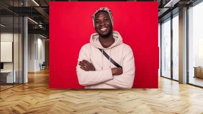 Portrait of a handsome man isolated on a red background Wall mural